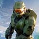 The Master Chief, in his green armor, standing in front of alien structures.